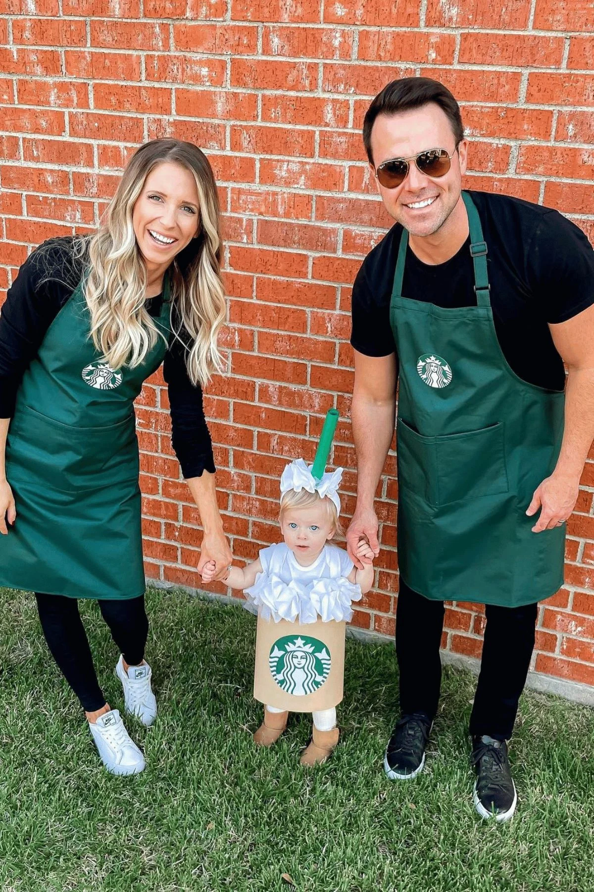 Mom and dad dressed as Starbuck's workers, daughter dressed as a Starbuck's drink