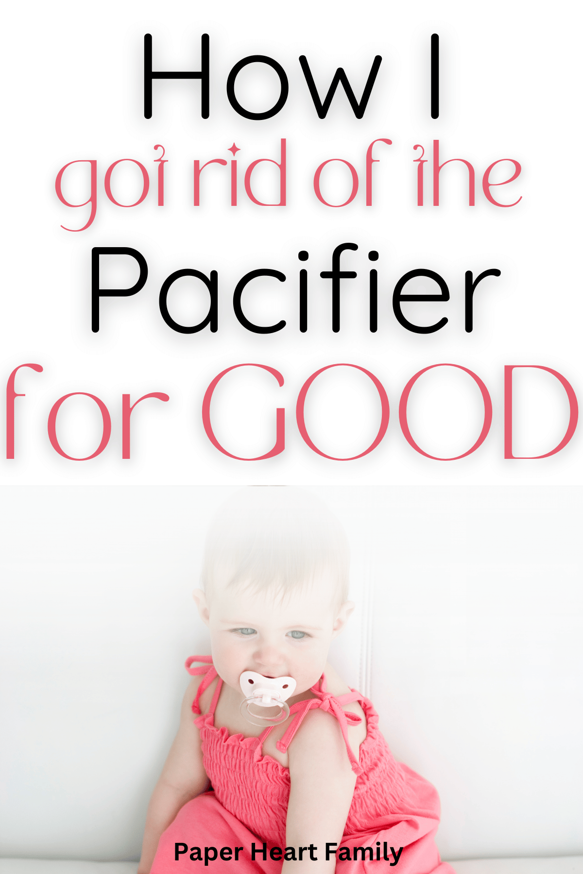 Baby girl sitting up with pacifier