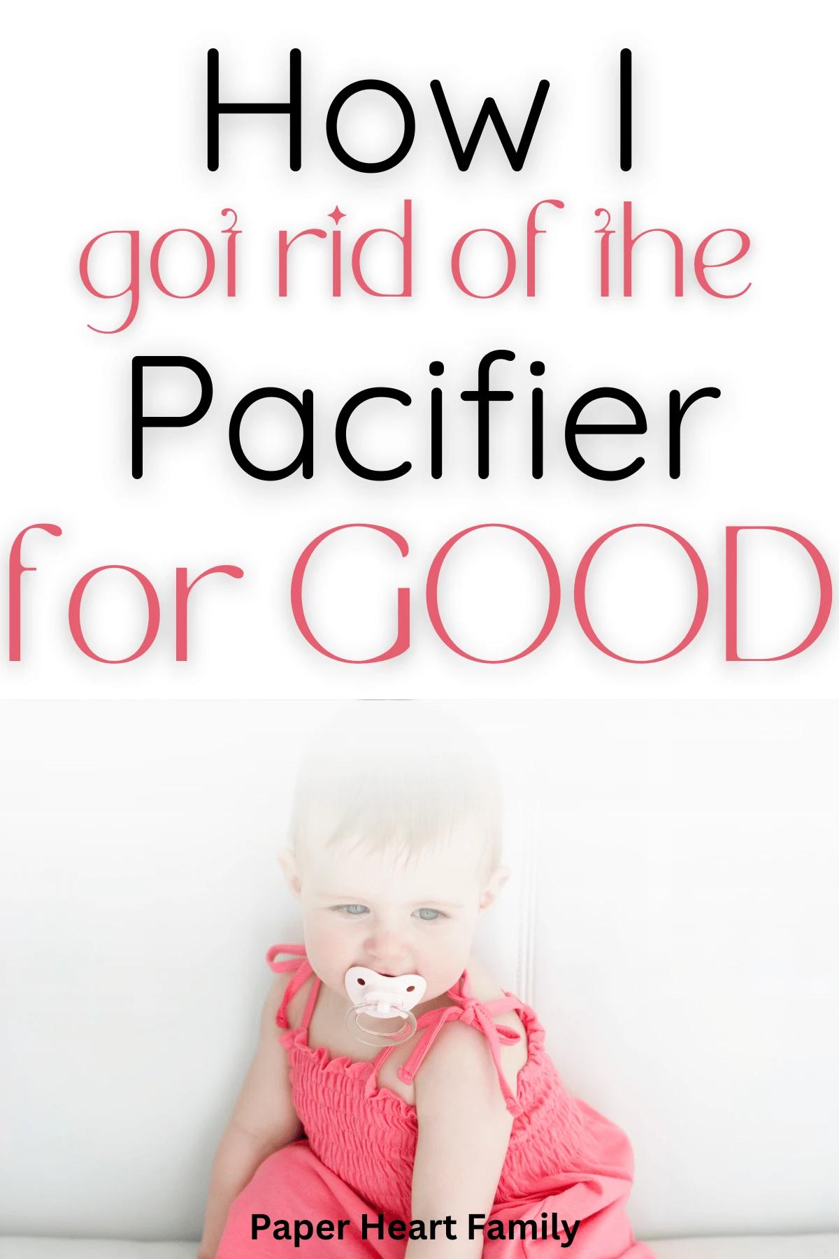 Baby girl sitting up with pacifier