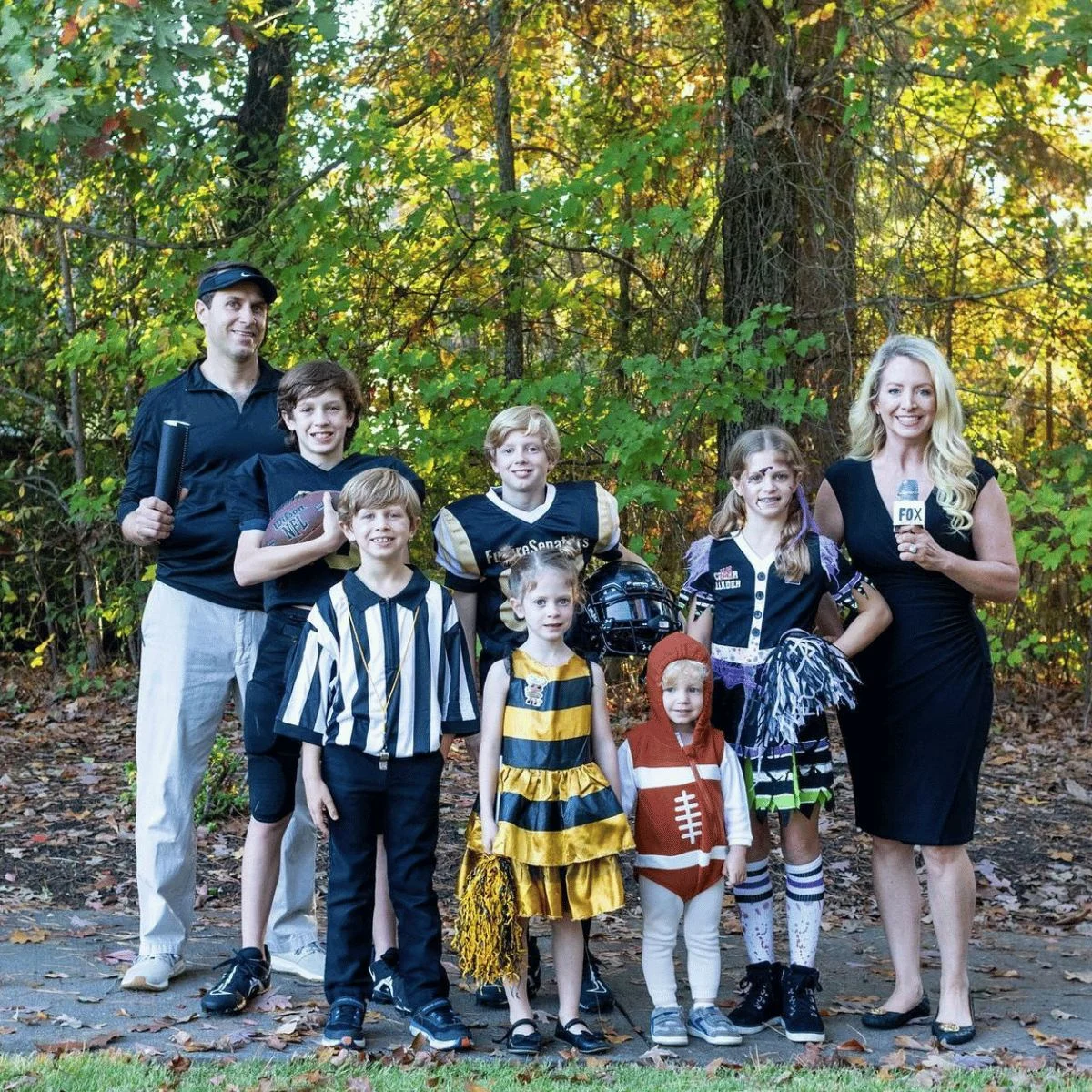 Family of 8 dressed as football players, refs, announcers, football and cheerleader